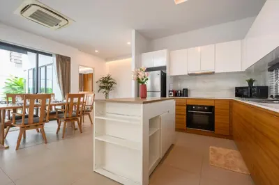 a kitchen and dining room with a table and chairs at New Luxury Pool Villa Bangtao Phuket in Ban Pak Lak