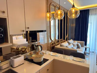 a room with a kitchen and a living room at Bangtao new studio in Bellevue Lagoon in Laguna Phuket