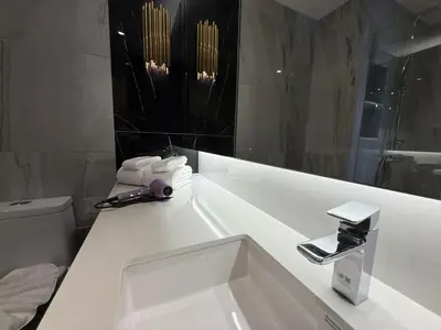 a white bathroom with a sink and a mirror at Bangtao new studio in Bellevue Lagoon in Laguna Phuket