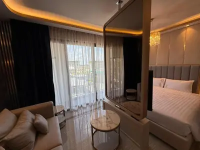 a hotel room with a large bed and a couch at Bangtao new studio in Bellevue Lagoon in Laguna Phuket