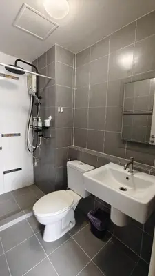 a bathroom with a toilet and a sink at The Azure Kathu in Kathu
