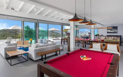 a living room with a red pool table at Tropical Castle Villa in Phuket Town