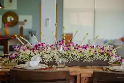 a table with purple and white flowers on it at Tropical Castle Villa in Phuket Town