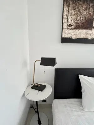 a bedroom with a bed and a table with a laptop on it at Apartment with sea view 2 beds in Kamala Beach
