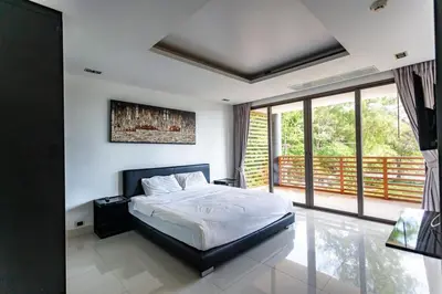 a bedroom with a bed and a large window at Apartment with sea view 2 beds in Kamala Beach