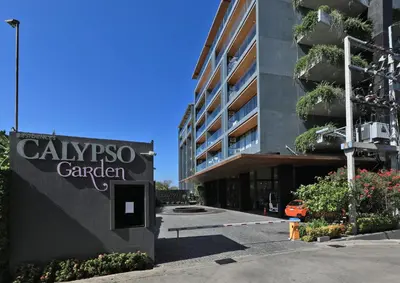 a sign for the calypso garden in front of a building at Stylish apartments in Calypso Garden condo, Sea View! in Rawai Beach