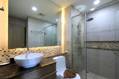 a bathroom with a sink and a glass shower at Stylish apartments in Calypso Garden condo, Sea View! in Rawai Beach