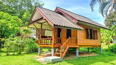 a small wooden house with a large porch at Affordable shack in Ban Laem Sai