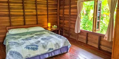 a bedroom with a bed and a window at Affordable shack in Ban Laem Sai
