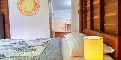a bedroom with a bed and a yellow lamp at Affordable shack in Ban Laem Sai