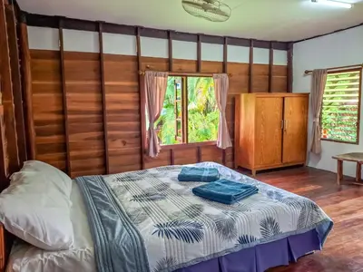 a bedroom with a bed and a window at Affordable shack in Ban Laem Sai