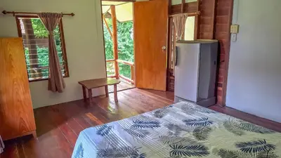 a room with a refrigerator and a bed in it at Affordable shack in Ban Laem Sai