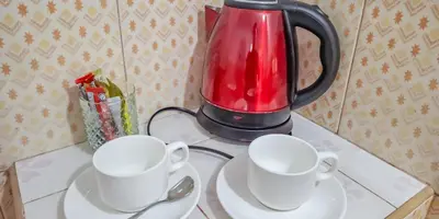 two tea cups and a blender on a table at Affordable shack in Ban Laem Sai