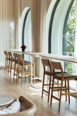 a table and chairs in a room with windows at Cute apartment 52 m2 in Brand New condo! BangTao in Bang Tao Beach