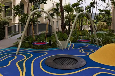 a playground at a resort with two swings at Cute apartment 52 m2 in Brand New condo! BangTao in Bang Tao Beach