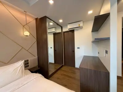 a small bedroom with a bed and a mirror at New Apartment on the 1floor in The Proud Karon in Karon Beach