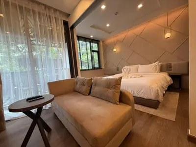 a bedroom with a bed and a couch at New Apartment on the 1floor in The Proud Karon in Karon Beach