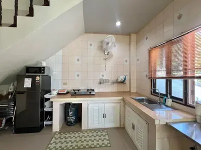 a kitchen with a sink and a black refrigerator at Kamala Charming Local House near Kamala Beach in Kamala Beach