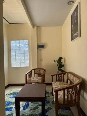 a living room with two chairs and a table at Kamala Charming Local House near Kamala Beach in Kamala Beach