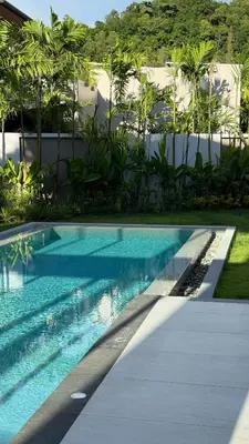 a swimming pool that is next to a building at Lake View Landscape Modern villa Bang Tao in Ban Thalat Choeng Thale