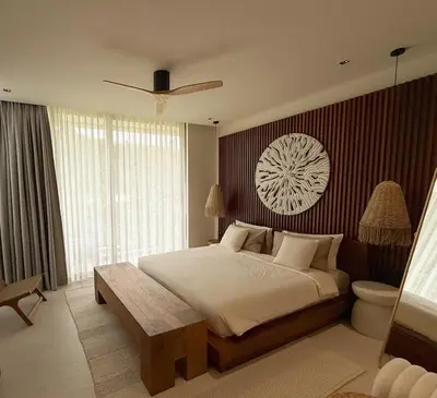 a bedroom with a large bed with a wooden table at Lake View Landscape Modern villa Bang Tao in Ban Thalat Choeng Thale
