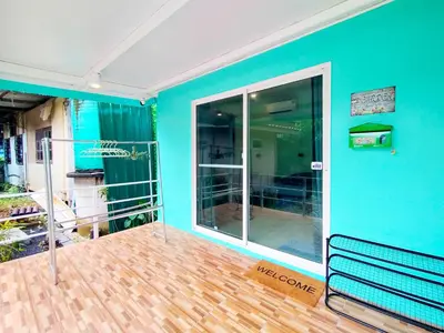 a empty room with a blue wall and a bench at Palm Garden house 1 close to Bang Tao beach in Ban Phak Chit
