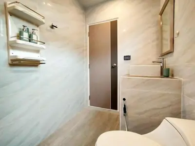 a bathroom with a toilet and a sink at Palm Garden house 1 close to Bang Tao beach in Ban Phak Chit