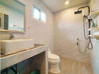 a bathroom with a sink and a toilet and a mirror at Palm Garden house 1 close to Bang Tao beach in Ban Phak Chit
