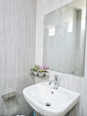 a white bathroom with a sink and a mirror at 4 bedroom Lucky House Patong in Patong Beach