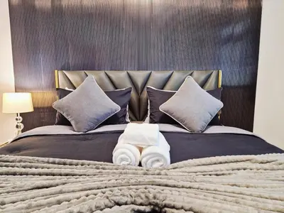 a bedroom with a large bed with two towels on it at 4 bedroom Lucky House Patong in Patong Beach