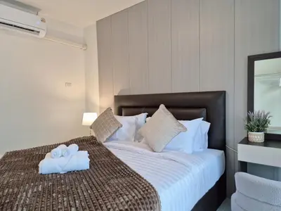 a bedroom with a bed with two towels on it at 4 bedroom Lucky House Patong in Patong Beach