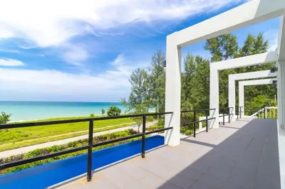 a view of the ocean from the balcony of a house at Black Pearl 8 Bedroom Beach Villa Private Pool Gym Free Car Free Water and Electricity Maid 10 Meters to the Beach in Mai Khao Beach