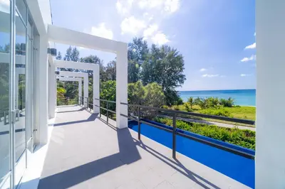 a balcony with a view of the ocean at Black Pearl 8 Bedroom Beach Villa Private Pool Gym Free Car Free Water and Electricity Maid 10 Meters to the Beach in Mai Khao Beach