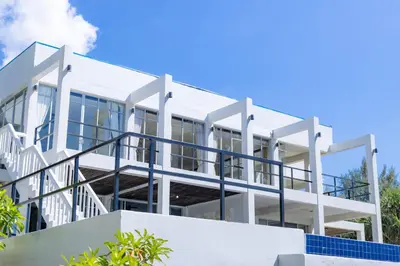 an image of a white building at Black Pearl 8 Bedroom Beach Villa Private Pool Gym Free Car Free Water and Electricity Maid 10 Meters to the Beach in Mai Khao Beach