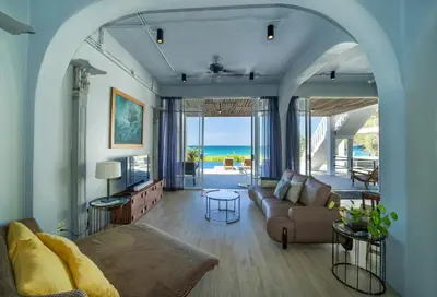 a living room with a couch and a table at Black Pearl 8 Bedroom Beach Villa Private Pool Gym Free Car Free Water and Electricity Maid 10 Meters to the Beach in Mai Khao Beach