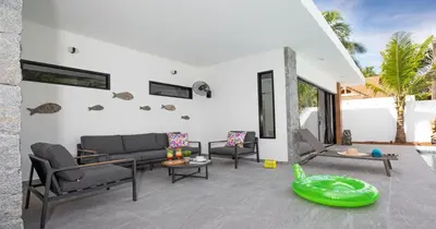 a living room with a couch and chairs at Stunning Pool Villa Curtis - 5 Bedrooms in the heart of Rawai in Rawai Beach