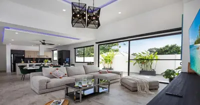 a living room with a couch and a table at Stunning Pool Villa Curtis - 5 Bedrooms in the heart of Rawai in Rawai Beach