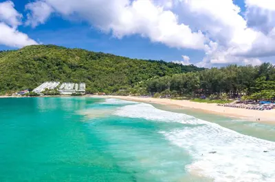 a beach with turquoise water and a mountain at Stunning Pool Villa Curtis - 5 Bedrooms in the heart of Rawai in Rawai Beach
