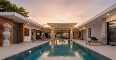 an indoor swimming pool in a house at Stunning Pool Villa Curtis - 5 Bedrooms in the heart of Rawai in Rawai Beach