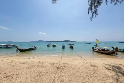 a group of boats in the water on a beach at Holiday Villa 2-BR J10, Private Pool, Rawai Beach in Phuket Town