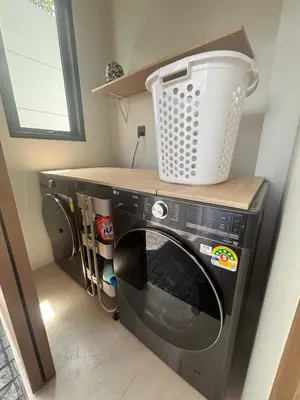 a washing machine with a bucket on top of it at Phuket Moana Pool Villa in Ban Na Nai