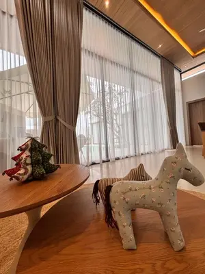 a wooden toy horse sitting on top of a table at Phuket Moana Pool Villa in Ban Na Nai