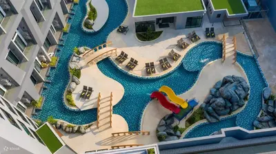 an aerial view of a pool at a resort at Utopia Lofts by Sabai Sands in Nai Harn Beach