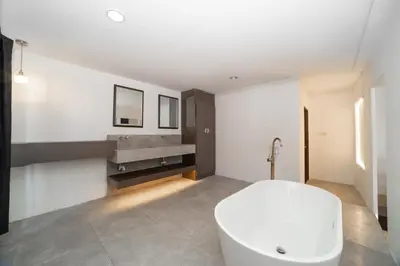 a bathroom with a white tub and a sink at Patong Thai-style 4 Bedrooms Private Pool Sunset View Deck 6 Minutes to the Beach in Patong Beach
