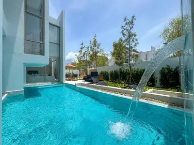 a swimming pool with a water fountain in front of a house at NEW! Luxury Pool Villa 4 Bedrooms in Lux Pride L27 Residence in Ban Pak Lak