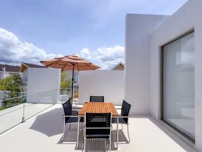 a dining room with a table and chairs and an umbrella at NEW! Luxury Pool Villa 4 Bedrooms in Lux Pride L27 Residence in Ban Pak Lak