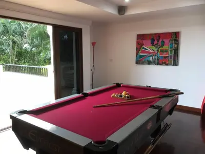 a pool table in a living room with at Villa Oriole - Luxury Pool Villa in Layan Beach
