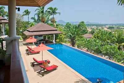 a pool at a resort with chairs and umbrellas at Villa Oriole - Luxury Pool Villa in Layan Beach