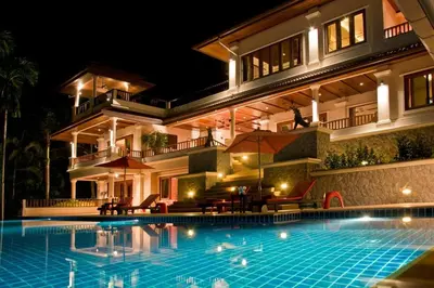 a villa with a swimming pool at night at Villa Oriole - Luxury Pool Villa in Layan Beach