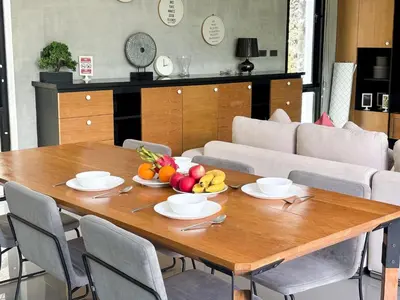 a wooden table with a bowl of fruit on it at Design Duplex Pavillion 2 BR Natural Park P11 in Kamala Beach